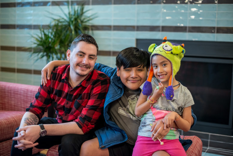 Image of Adult and Two Kids smiling together